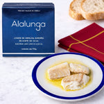 Alalunga packaging with a plate of hake loins on a marble surface