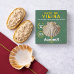 Scallops pate on bread with a green Agromar packaging on a white marble surface