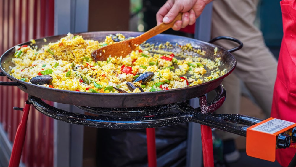 paella pan on a burner and legs
