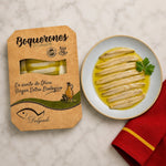 Packaged product of Boquerones en vinagre with a plate of dish on a marble surface