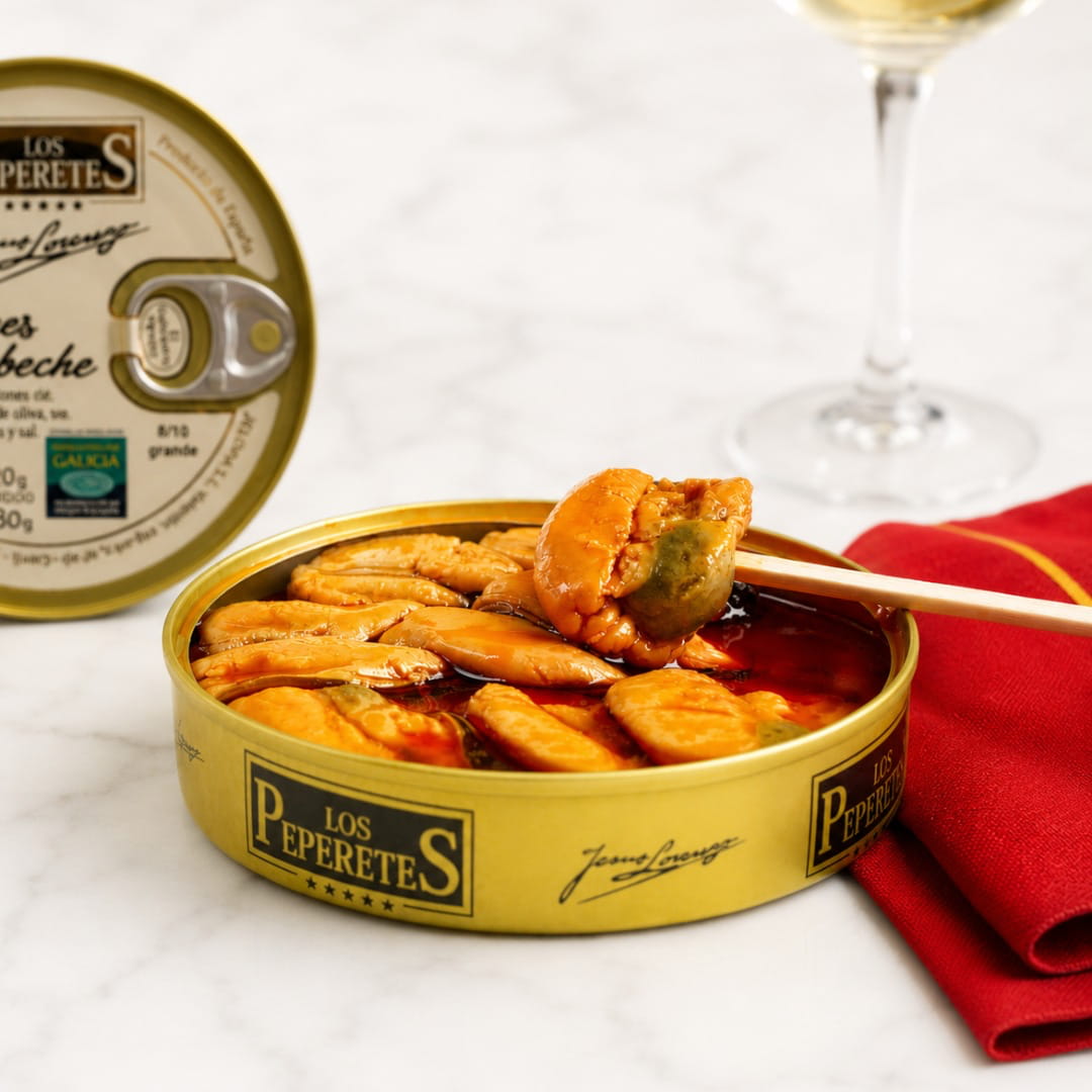 Can of mussels escabeche Los Peperetes with a red cloth and wine glass in the background