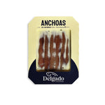 Packaged Cantabrian anchovies preserved in butter, branded by Delgado, with a white and blue label.