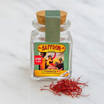 Jar of saffron with a label on a white background