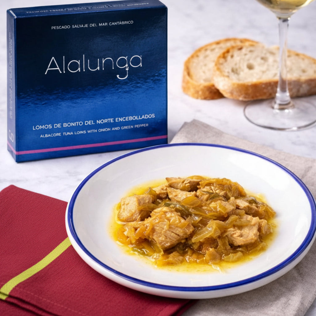 Plate of bonito in onion sauce with a box labeled 'Alalunga' in the background
