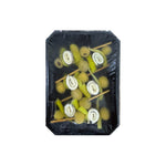 Packaged skewers of boquerones anchovies, olives, and pickled green peppers on a black background.