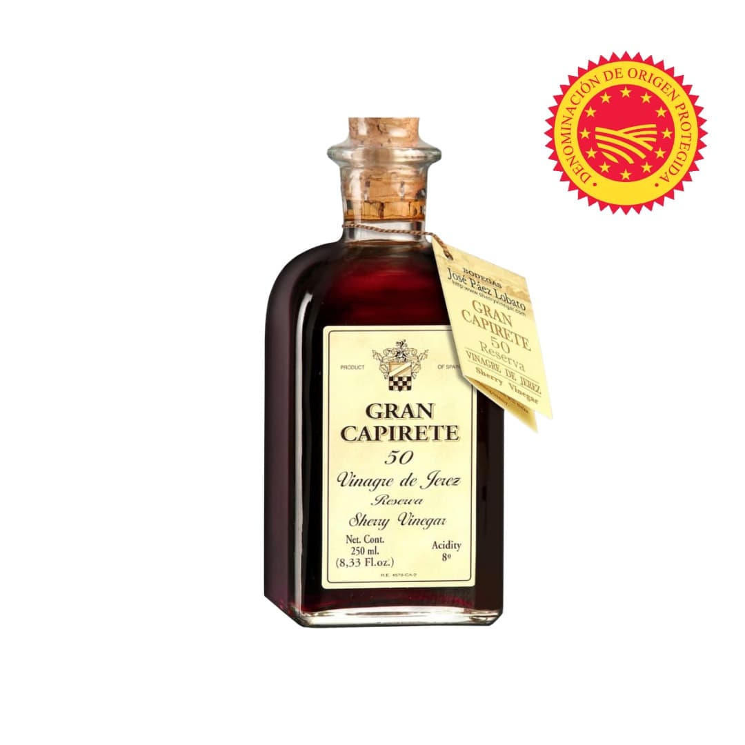 Bottle of Gran Capirete sherry vinegar with a label and a red seal on a white background