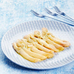Los Peperetes razor clams on a blue textured plate with two forks.