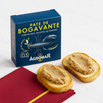 Box of Agromar lobster pate with two slices of bread spread with pate on a white background