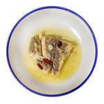 seabass in a plate with a blue rim on a white background