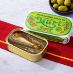 Nuri spiced mackerel in olive oil can with green label on a red and white striped cloth.